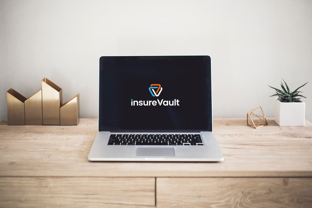insureVault broker portal displayed on a laptop